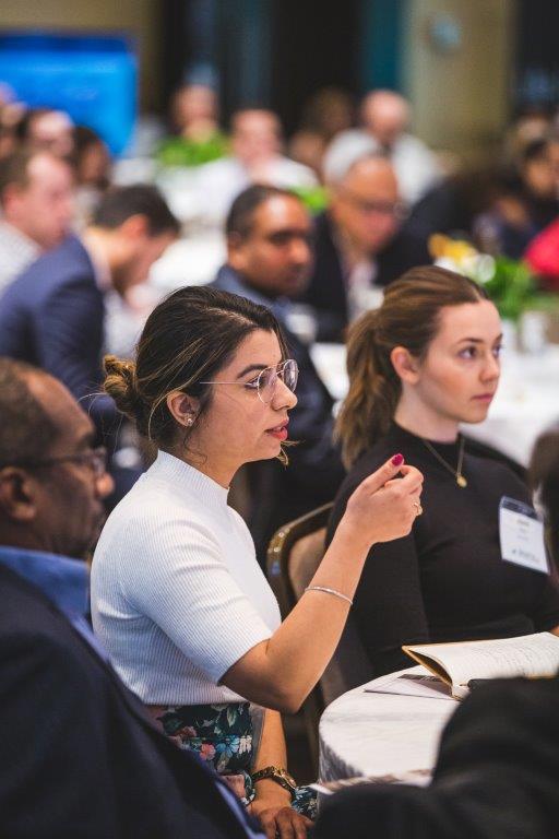 woman asking question at conference